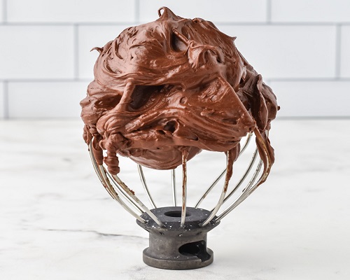 a brown frosting on a wire whisk